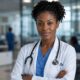 An AI-generated photo of a professional Black female healthcare worker sitting at a desk with a stethoscope, representing a medical expert delivering a public health advisory.