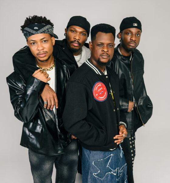 A tight group studio portrait of Nollywood stars Mike Afolarin, Chimezie Imo, Emeka Nwagbaraocha, and Tomiwa Tegbe looking directly into the camera in coordinated black jackets and streetwear.