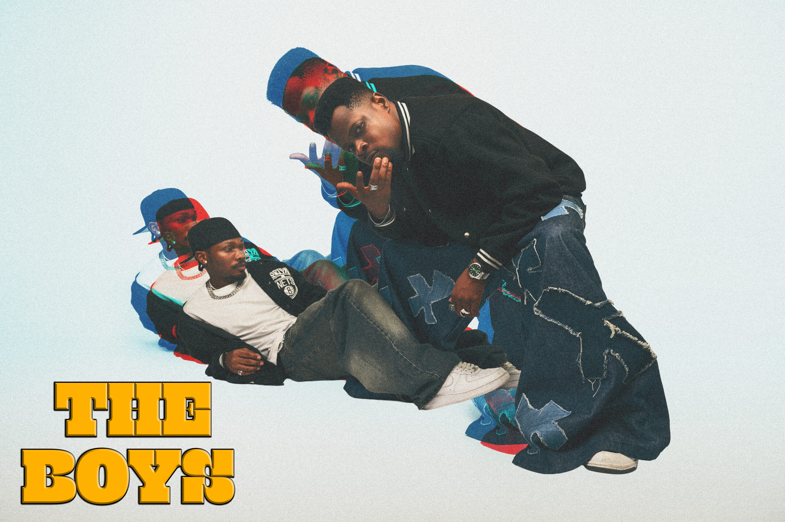 A stylised pop-art promotional image with 3D red and blue shadow effects featuring Emeka Nwagbaraocha and Chimezie Imo in streetwear, with yellow text in the bottom left corner reading "THE BOYS".