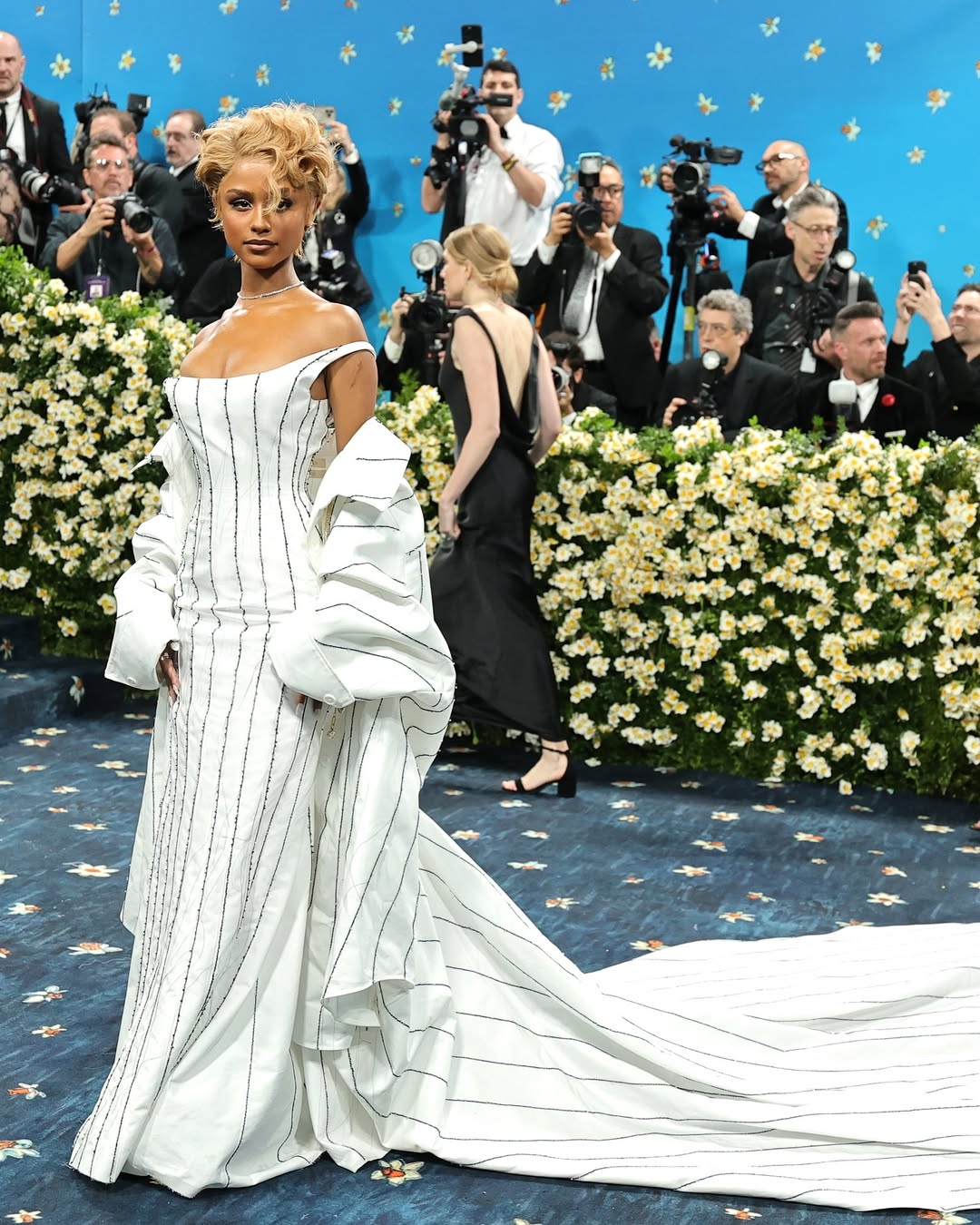 Tyla in a custom Jacquemus navy pinstripe corset dress and floor-length shirt cape for the 2025 Met Gala.