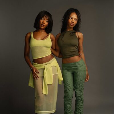 Ayra Starr and YouTube creator Quenlin Blackwell posing for a professional portrait during their 2026 collaborative episode.