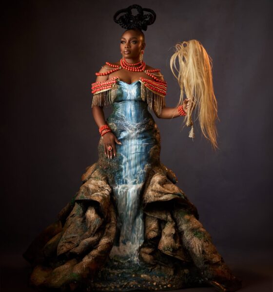 Bisola Aiyeola at the AMVCA 12 Cultural Night wearing an Igbo-inspired "Mmiri Ndu" waterfall gown and holding a traditional horsetail.