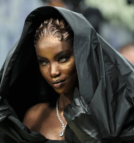 Profile of Anok Yai in Balenciaga hooded gown at Met Gala 2026 showing the metallic bronze skin finish and hand-sculpted prosthetic hair.