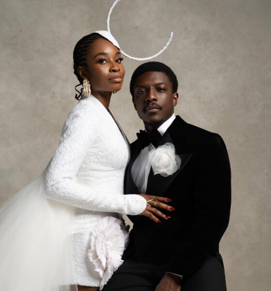 Call of My Life lead actors Uzoamaka Aniunoh in an avant-garde white lace blazer dress with a sculptural headpiece and Andrew Bunting in a black velvet tuxedo posing together at the 12th Africa Magic Viewers' Choice Awards (AMVCA).