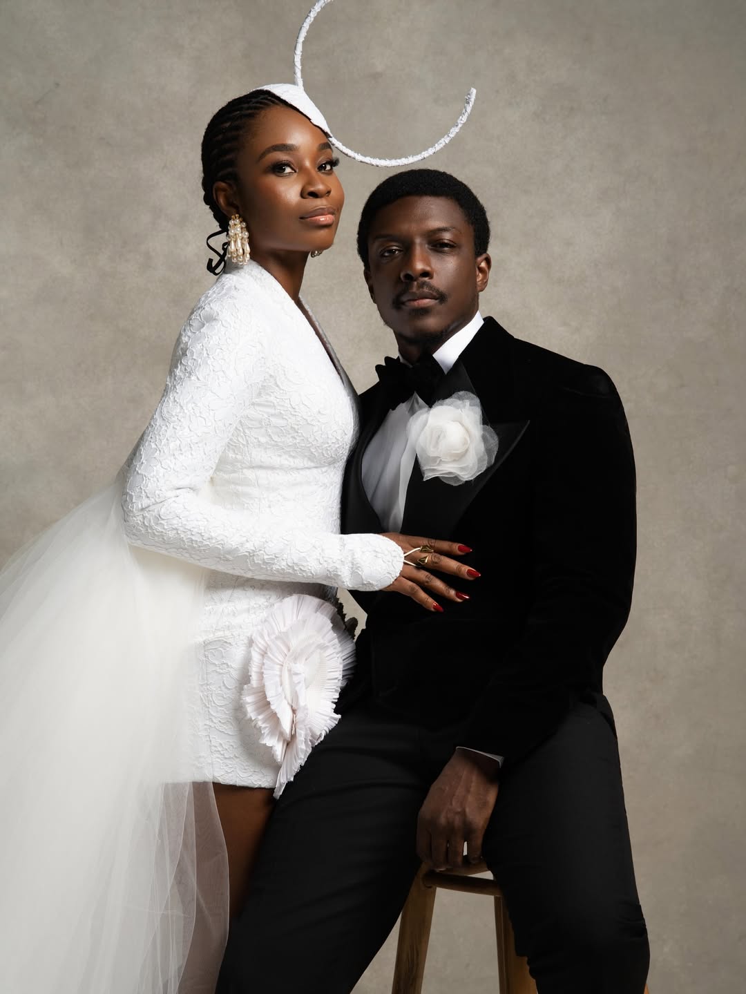 Call of My Life lead actors Uzoamaka Aniunoh in an avant-garde white lace blazer dress with a sculptural headpiece and Andrew Bunting in a black velvet tuxedo posing together at the 12th Africa Magic Viewers' Choice Awards (AMVCA).
