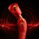 Osas Ighodaro showcasing the "shelf" hip detail and spiral band structure of her Veekee James AMVCA gown.