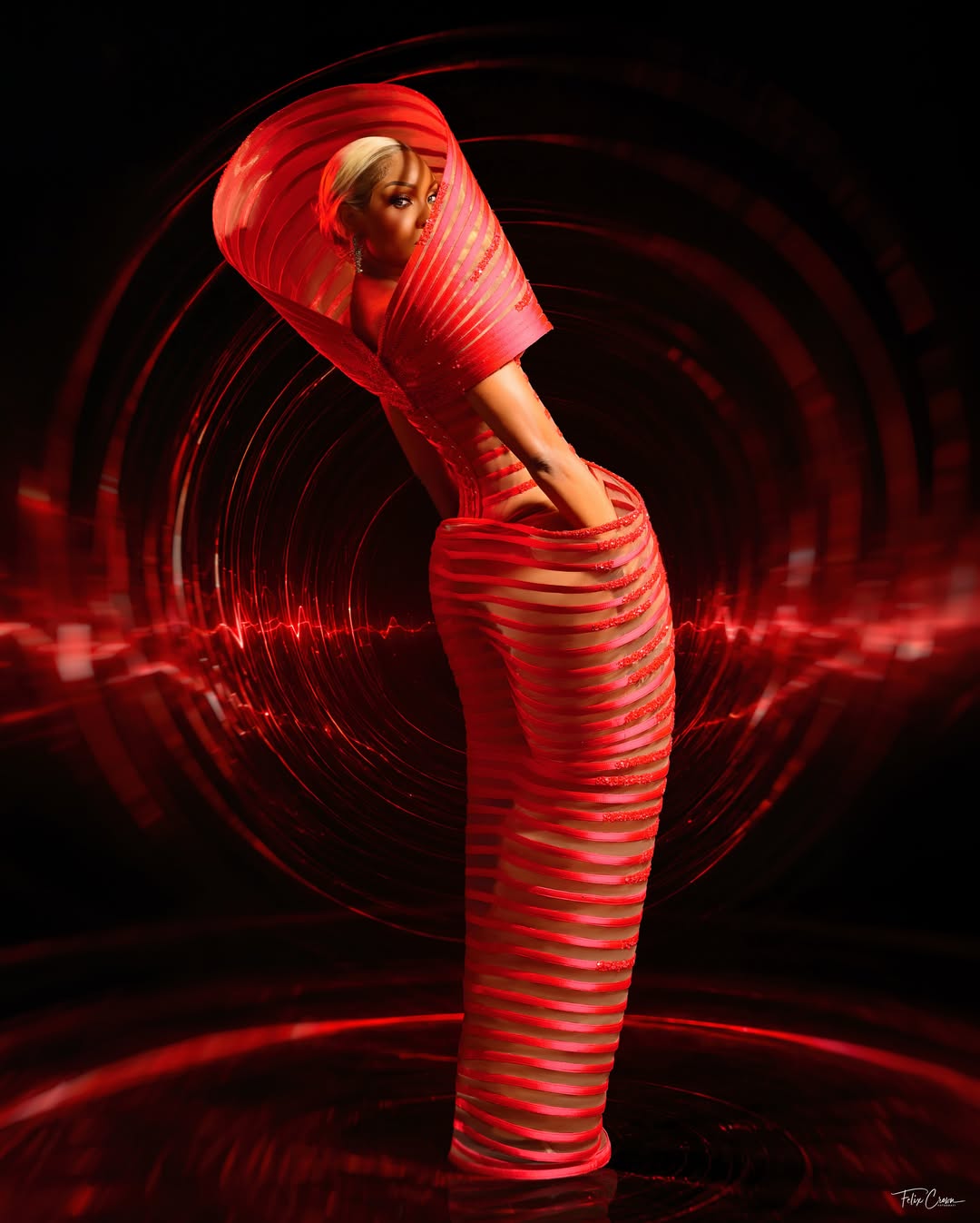 Osas Ighodaro showcasing the "shelf" hip detail and spiral band structure of her Veekee James AMVCA gown.