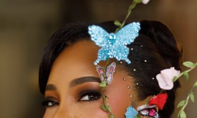 A close-up portrait of Linda Ejiofor-Suleiman featuring butterfly hair ornaments and soft glam makeup for the 2026 AMVCA.