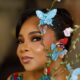 A close-up portrait of Linda Ejiofor-Suleiman featuring butterfly hair ornaments and soft glam makeup for the 2026 AMVCA.