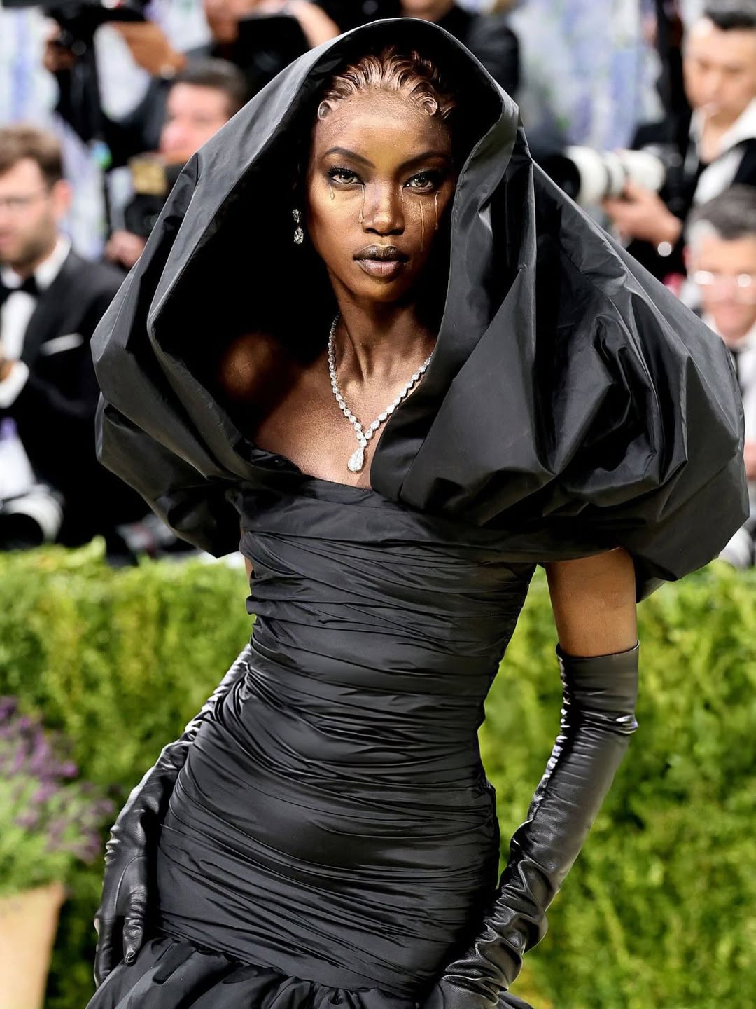 Anok Yai at Met Gala 2026 wearing a custom Balenciaga Black Madonna gown by Pierpaolo Piccioli with a sculptural silk taffeta hood and opera gloves.