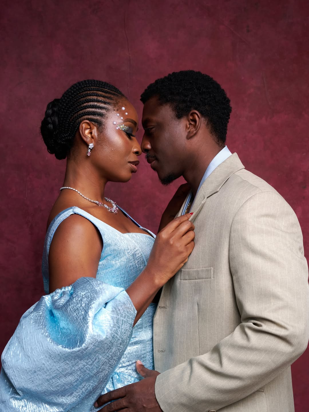 Uzoamaka Power and Andrew Bunting posing closely together in coordinated blue outfits at the Call of My Life premiere.