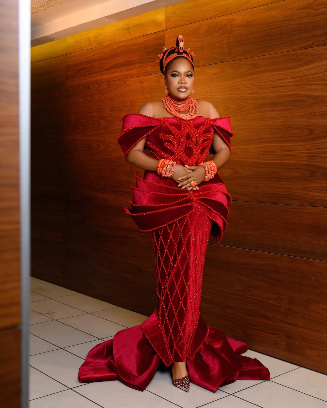 Toyin Abraham wearing a royal Edo-inspired crimson velvet mermaid gown by Prudent Gabriel with an Okuku crown and coral beads at AMVCA 2026 Cultural Night.