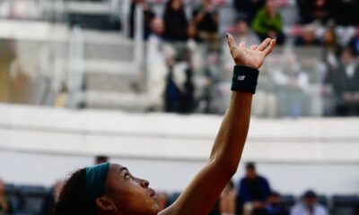 Coco Gauff tossing the ball for a serve in front of a crowded stadium during the 2026 Italian Open semifinals.