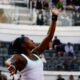 Coco Gauff tossing the ball for a serve in front of a crowded stadium during the 2026 Italian Open semifinals.