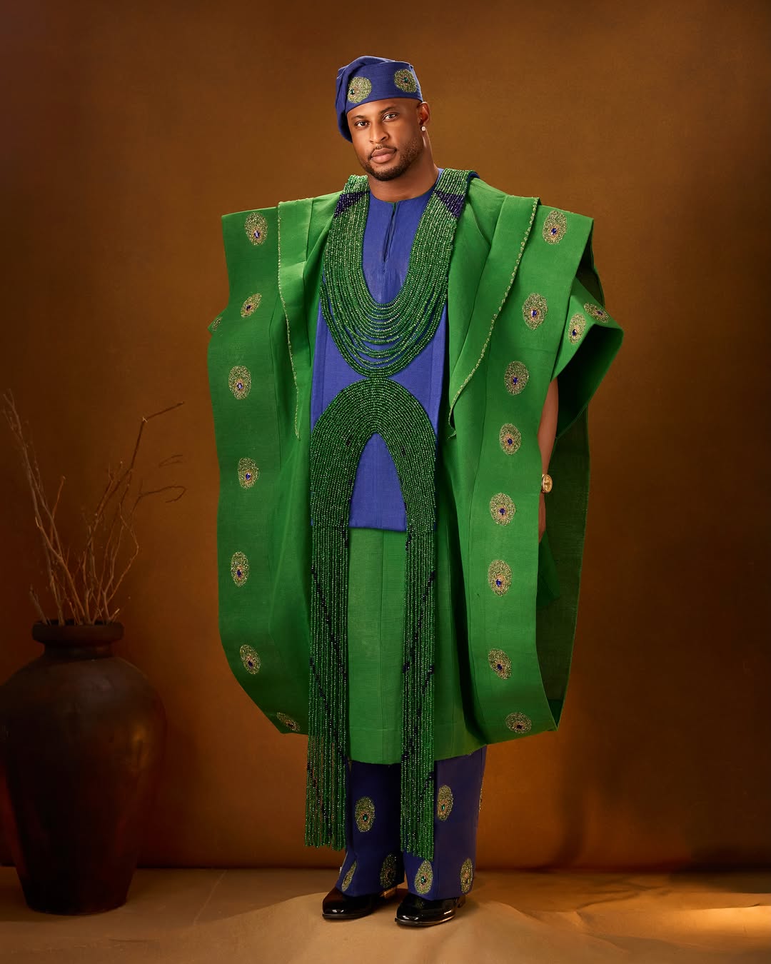 Kaybobo in a green and purple Aso-Oke Agbada inspired by the peacock for the AMVCA 12 Cultural Night.