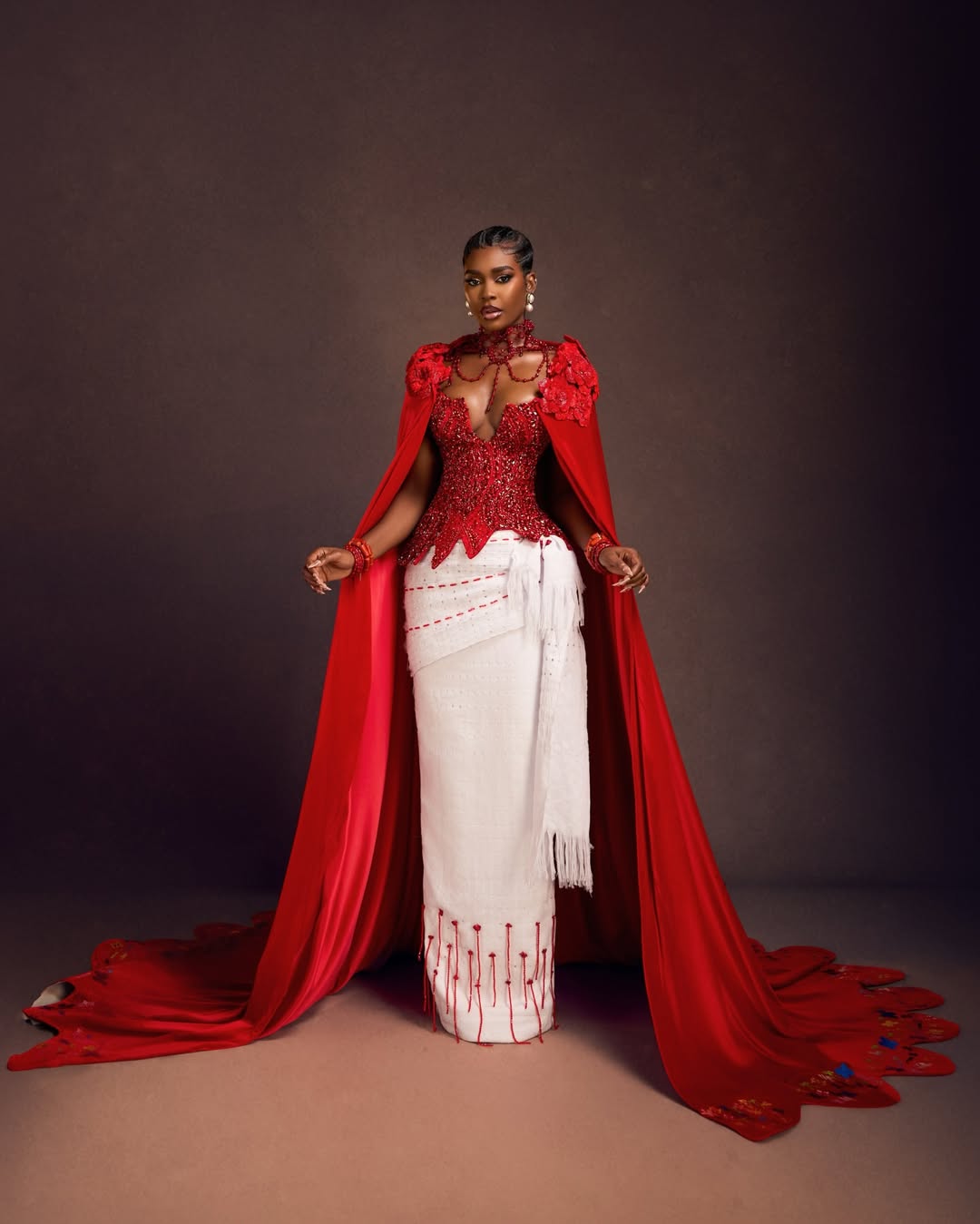 BBNaija’s Dede in a wine velvet corset dress and white Akwa Ocha wrapper representing Delta State heritage at AMVCA 12.