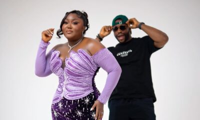 Blessing Nze in a purple velvet mermaid gown with silver starburst embellishments, with husband Stan Nze visible in the background.