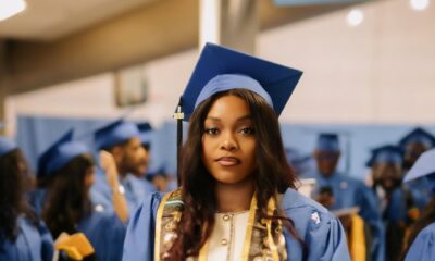 Lilo Aderogba standing in her academic gown among fellow graduates during a commencement ceremony.