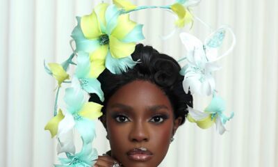 Close-up portrait of Beverly Osu showing her floral headpiece, teal lace corset, and glowy makeup for the Call of My Life premiere.