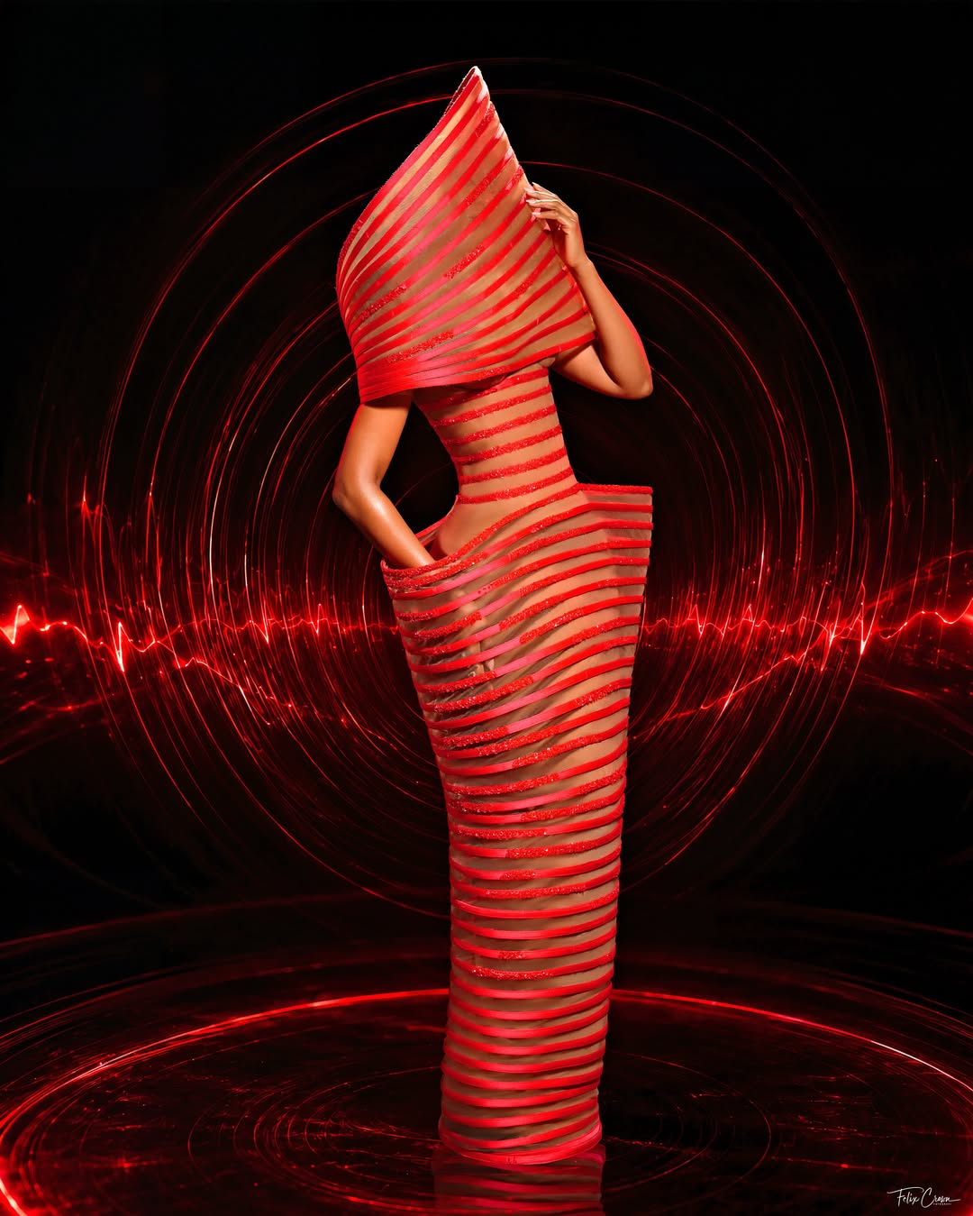 Osas Ighodaro in a red sculptural gown by Veekee James with a high structured collar.