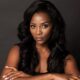 A portrait of Nigerian actress Genevieve Nnaji with long wavy hair and white manicured nails, confirmed as part of the BBC Wahala cast.