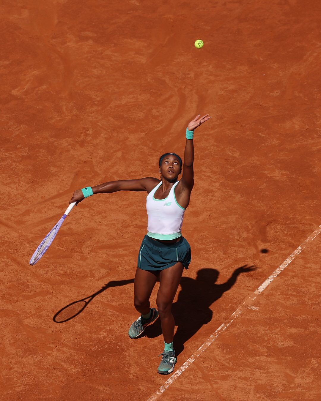 Coco Gauff in mid-serve during the 2026 Rome semifinals against Sorana Cirstea.