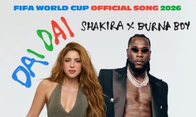 Official single cover for "Dai Dai" featuring Shakira holding a football and Burna Boy in an open black suit jacket and diamond chains.