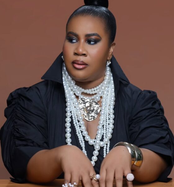 Close-up of Chioma "Chigurl" Omeruah’s birthday glam featuring smoky eyes, a sleek top knot, and layered pearl necklaces.