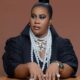 Close-up of Chioma "Chigurl" Omeruah’s birthday glam featuring smoky eyes, a sleek top knot, and layered pearl necklaces.