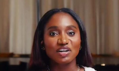 Tiwi Remi, wife of Nollywood actor Kunle Remi, seated in a podcast interview setting wearing a black and white bicolour knit cardigan and layered gold necklaces for the debut episode of her YouTube podcast Bare by BKO