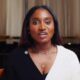 Tiwi Remi, wife of Nollywood actor Kunle Remi, seated in a podcast interview setting wearing a black and white bicolour knit cardigan and layered gold necklaces for the debut episode of her YouTube podcast Bare by BKO