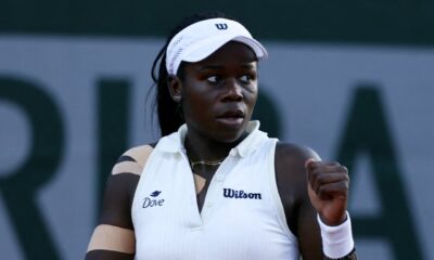 Ninth seed Victoria Mboko clenching her fist in celebration on the clay court after winning a point during her first-round match at the 2026 French Open.
