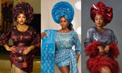Mercy Aigbe in a burgundy brocade dress, Nelly Mbonu in a blue lace gown with a train, and Bimbo Akintola in a sequinned dress with red feathers.