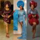 Mercy Aigbe in a burgundy brocade dress, Nelly Mbonu in a blue lace gown with a train, and Bimbo Akintola in a sequinned dress with red feathers.