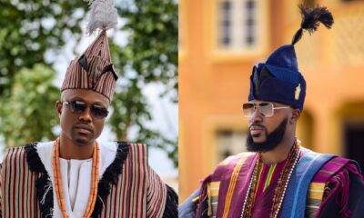 A side-by-side photo showcasing Vector in a fringed geometric striped robe and Akin Faminu in a vibrant layered wine and blue Aso-Oke ensemble with a tall tasseled fila at Ojude Oba 2026.