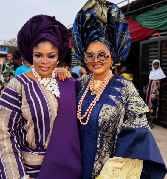 Nollywood actresses Eniola Ajao and Mercy Aigbe in traditional Yoruba Aso Oke and elaborate geles wearing statement sunglasses on the set of Iwe Ala.