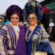 Nollywood actresses Eniola Ajao and Mercy Aigbe in traditional Yoruba Aso Oke and elaborate geles wearing statement sunglasses on the set of Iwe Ala.