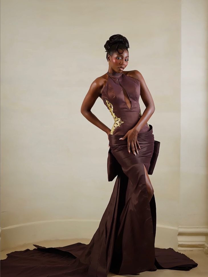 Tamunosoye Karibi George posing in a structured halter-neck brown satin gown with a high slit during the pageant preliminaries.