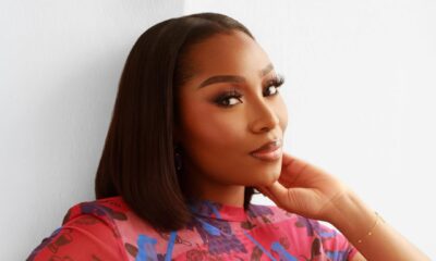 Close-up of beauty influencer Dimma Umeh showcasing a soft-glam matte makeup look and a sleek, middle-parted straight bob hairstyle.