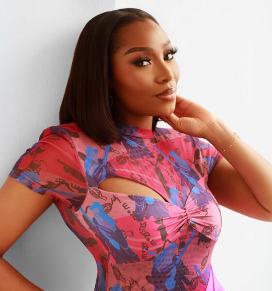 Close-up of beauty influencer Dimma Umeh showcasing a soft-glam matte makeup look and a sleek, middle-parted straight bob hairstyle.
