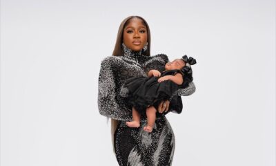 Fashion designer Veekee James holding her newborn daughter Eliana Adeife Atere in a coordinating black ruffled outfit for her 31st birthday.