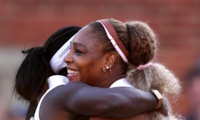 Serena Williams smiling warmly while embracing her doubles partner Victoria Mboko following their straight-sets victory.