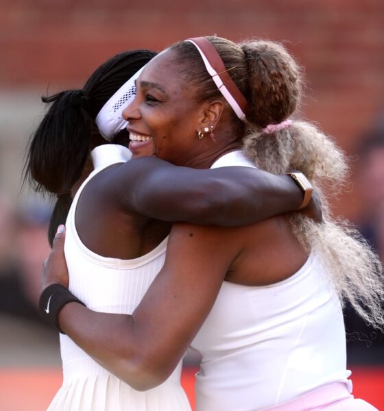 Serena Williams smiling warmly while embracing her doubles partner Victoria Mboko following their straight-sets victory.