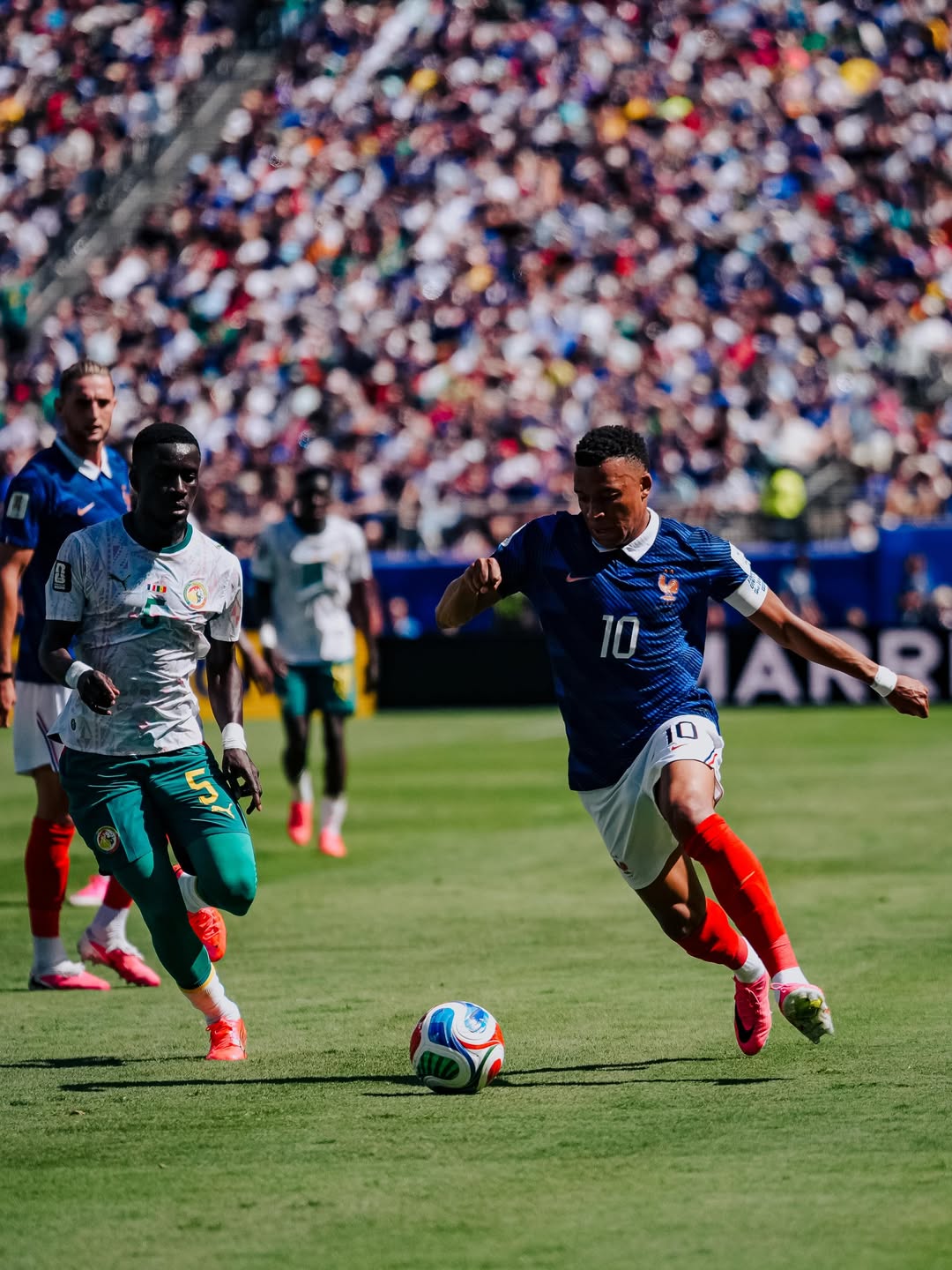 France captain Kylian Mbappe wearing the blue number 10 kit while controlling the football on the pitch during the match against Senegal.