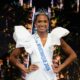 Maureen-Alycia Lucéa-Merlin wearing the Miss Martinique 2026 sash, crown, and gold drop earrings with her hands on her hips.