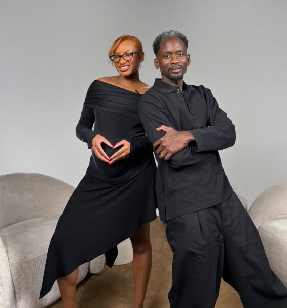 Temi Otedola shapes her hands into a heart over her baby bump alongside Mr Eazi on a studio set.