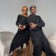 Temi Otedola shapes her hands into a heart over her baby bump alongside Mr Eazi on a studio set.