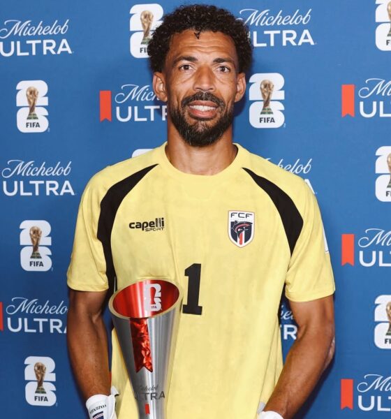 Cabo Verde goalkeeper Vozinha holding his official FIFA World Cup Man of the Match trophy in front of a blue sponsor backdrop.