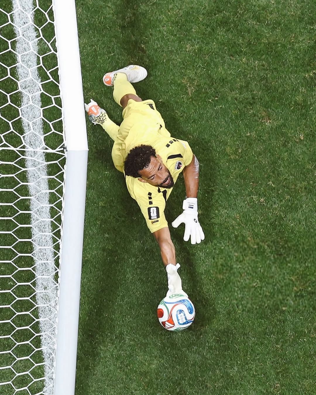 Cabo Verde goalkeeper Vozinha diving across the pitch to stop a shot during the World Cup match against Spain.