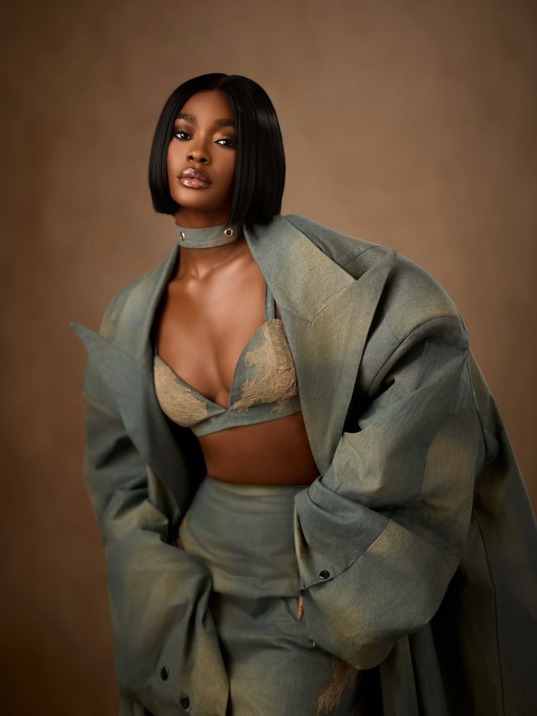 Dede Ashiogwu's BBNaija Season 10 reunion glam featuring a razor-sharp black bob, denim choker, and detailed floral lace on her bralette.